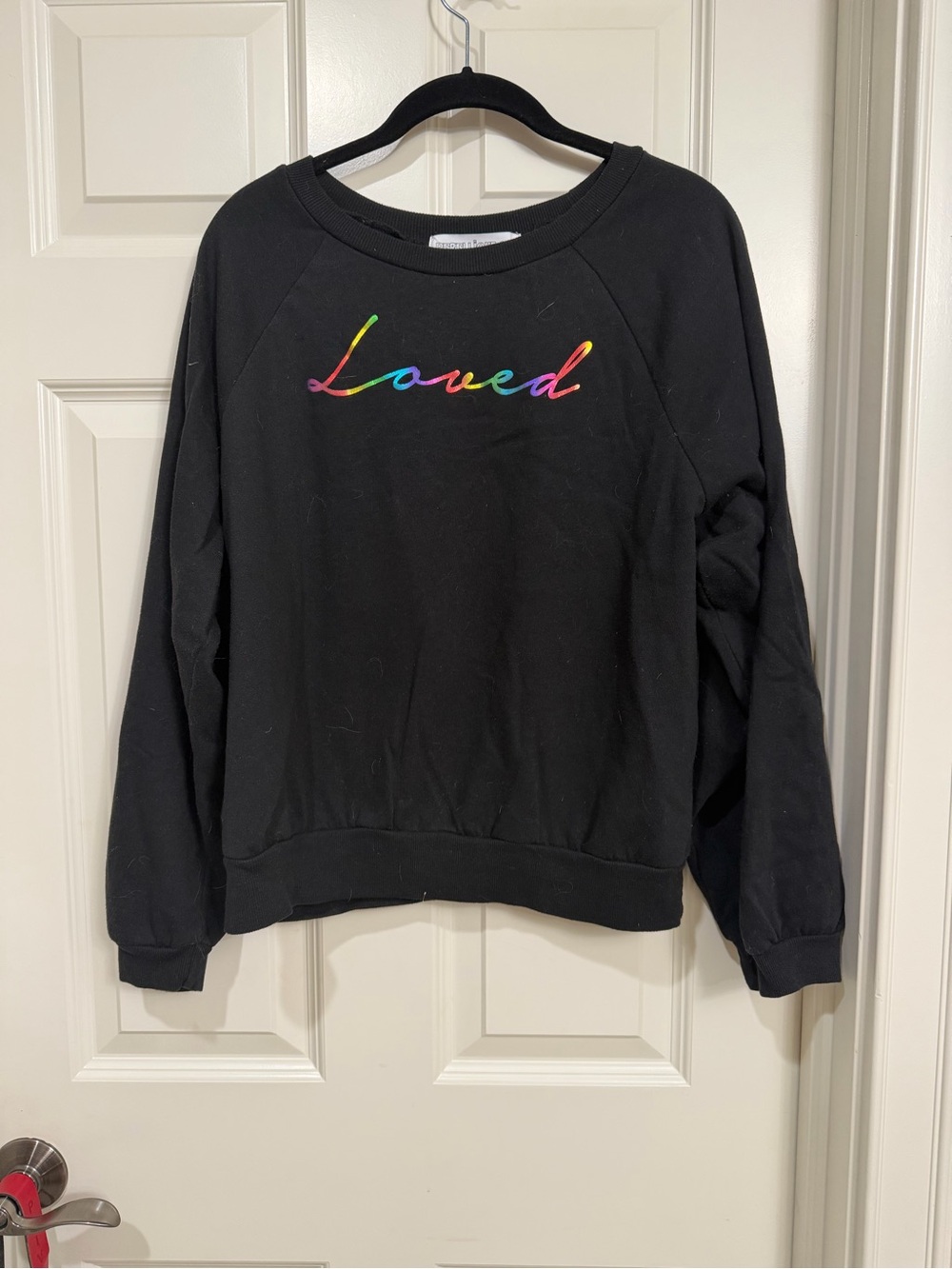 Rebellious One Black Crewneck Sweatshirt with Rainbow "Loved" Embroidery